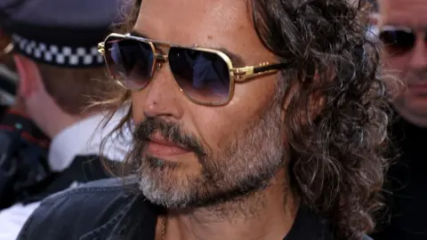Russell Brand arrives at court for first hearing